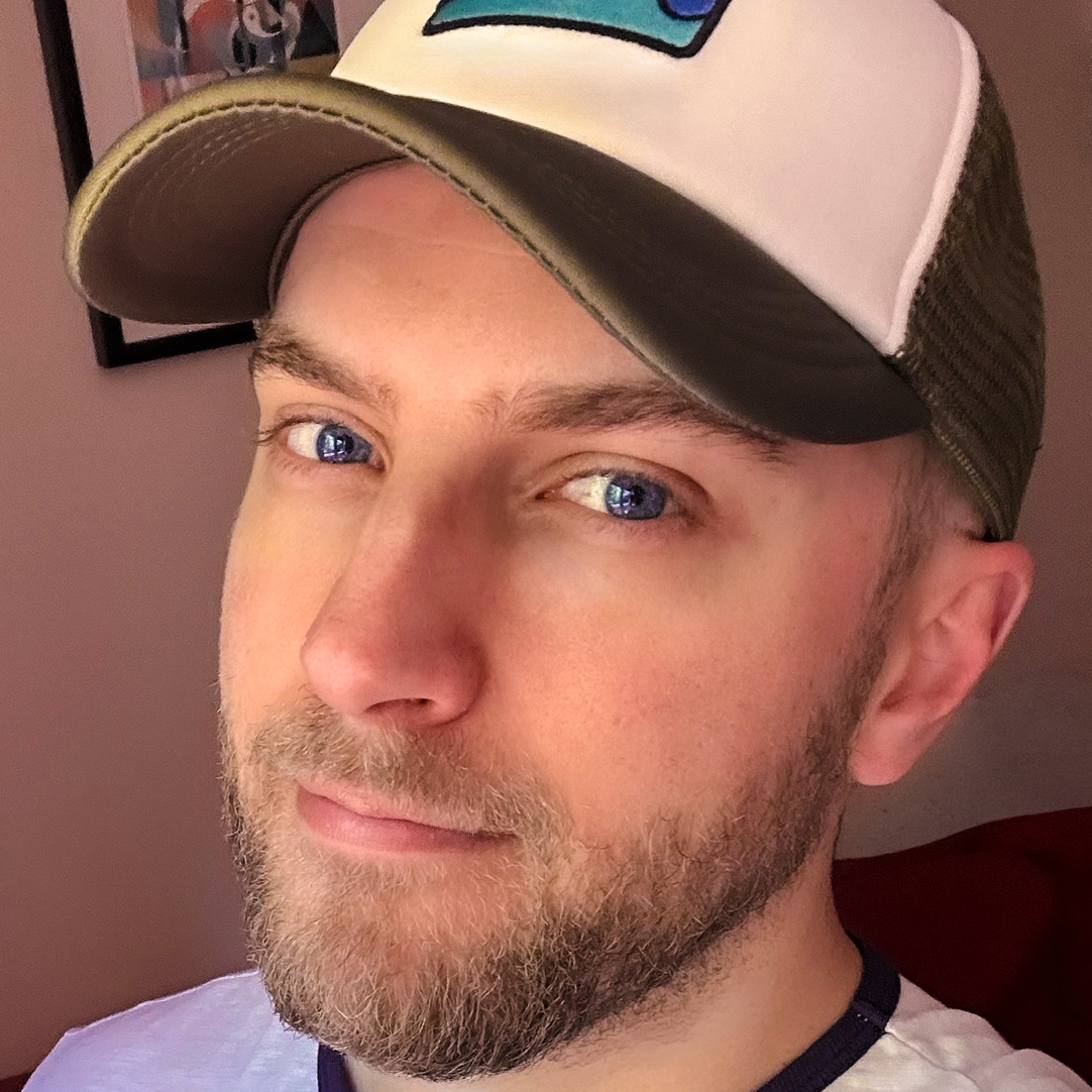 A headshot of Luke in a baseball cap.